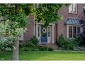 Close-up of home's entrance showcasing a blue door with wreath and brick steps at 895 Baywood Ct, Columbus, IN 47201