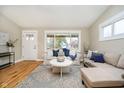 Bright living room with hardwood floors, large window, and comfortable seating arrangement at 900 W Oak St, Zionsville, IN 46077