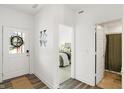 Inviting entryway featuring a stylish door, decor, and a view into the light-filled bedroom at 9264 Larson Dr, Pendleton, IN 46064