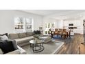 Bright, open-concept living space featuring modern furniture, a dining area, and wood flooring at 9264 Larson Dr, Pendleton, IN 46064