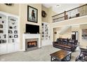 Cozy living room with fireplace, built-in bookshelves, and plush seating at 9643 N Box Elder Ct, McCordsville, IN 46055