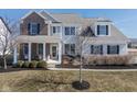 Charming two-story home with a brick and siding exterior, complemented by a cozy front porch at 10055 Win Star Way, Fishers, IN 46040
