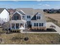 Aesthetic aerial view of a two-story home with a well-maintained lawn and a side basketball court at 10055 Win Star Way, Fishers, IN 46040