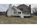 The back of the home features an elevated deck and large windows overlooking the yard at 10136 Summerlakes Dr, Carmel, IN 46032