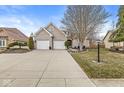 Beautiful brick home with a spacious driveway and attached two-car garage at 10140 Cheswick Ln, Fishers, IN 46037