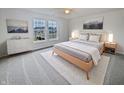 Cozy bedroom with modern furnishings, soft carpeting, neutral decor, and bright natural light at 11134 Westoves Dr, Noblesville, IN 46060