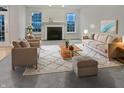 Bright living room with a fireplace, neutral decor, plush seating, and lots of natural light at 11134 Westoves Dr, Noblesville, IN 46060