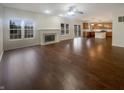 Spacious living room with hardwood floors, fireplace, neutral paint, and natural light from large windows at 12036 Weathered Edge Dr, Fishers, IN 46037