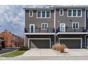 Contemporary townhouse with a private garage and a balcony, offering modern living spaces at 12723 Apsley Ln, Carmel, IN 46032