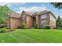 Spacious brick home with a manicured lawn and tasteful landscaping creating a welcoming curb appeal at 13133 Brooks Landing Pl, Carmel, IN 46033