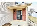 Inviting front porch with brick accents, bench, and plants at 15281 Proud Truth Dr, Noblesville, IN 46060