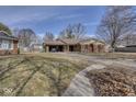 Lovely single-story home with an attached garage and a cozy front yard nestled in a quiet neighborhood setting at 1612 Westbay Ct, Indianapolis, IN 46260