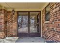 A charming front porch entrance with brick surround and double glass doors, creating an inviting curb appeal at 1612 Westbay Ct, Indianapolis, IN 46260