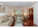 Cozy living room with hardwood floors, decorative couches, and bright natural light at 1612 Westbay Ct, Indianapolis, IN 46260