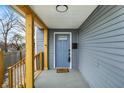 Charming front porch with wood columns, blue door, and gray wood-look siding at 1842 Tallman Ave, Indianapolis, IN 46218