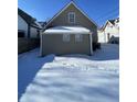 Backyard features a home exterior, a fence, and snow-covered ground at 2133 Webb St, Indianapolis, IN 46225