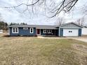 Charming blue house with a red front door and attached garage, great curb appeal at 2169 W State Road 234, Fortville, IN 46040