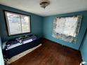 Simple bedroom with hardwood floors, a window letting in natural light, and a cozy atmosphere at 2503 S Lyons Ave, Indianapolis, IN 46241