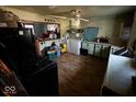 View of a kitchen featuring appliances, hardwood floors, and an open doorway at 2503 S Lyons Ave, Indianapolis, IN 46241