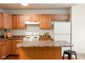 Well-lit kitchen with wooden cabinets, island, and modern appliances at 3038 Wildcat Ln, Indianapolis, IN 46203