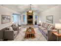 Bright living room featuring vaulted ceilings, stone fireplace and neutral colored furniture at 310 Hickory Dr, Greenfield, IN 46140