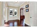 Bright entryway featuring wood floors, double doors, and classic architectural details at 3283 Homestretch Dr, Carmel, IN 46032
