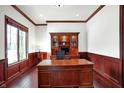 Spacious office featuring wood paneling, built in shelves, and a large desk at 3283 Homestretch Dr, Carmel, IN 46032