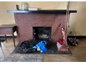 Close-up of brick fireplace with decorative mantel, ready for cozy evenings with room for firewood at 410 N Euclid Ave, Indianapolis, IN 46201