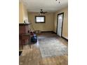 Inviting living room features a brick fireplace, hardwood floors, and natural light from the window at 410 N Euclid Ave, Indianapolis, IN 46201