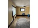Spacious living room boasts hardwood floors, bright windows, and a ceiling fan for comfort at 410 N Euclid Ave, Indianapolis, IN 46201