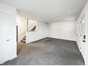 Spacious living room featuring neutral paint, plush carpet, and plenty of natural light at 415 W Gimber St, Indianapolis, IN 46225