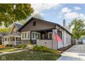 View of home featuring the architectural style, lawn, and American flag on the front porch at 4818 Guilford Ave, Indianapolis, IN 46205