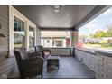 Relaxing front porch with wicker furniture, enhancing the home's curb appeal and charm at 4818 Guilford Ave, Indianapolis, IN 46205