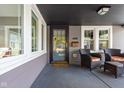 Cozy front porch with seating, offering a view of the neighborhood and natural light at 4818 Guilford Ave, Indianapolis, IN 46205