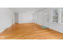Bright living room with hardwood floors, fresh paint, and many windows bringing in natural light at 488 N 24Th Ave, Beech Grove, IN 46107