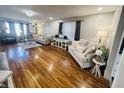 Spacious living room featuring hardwood floors, neutral décor, and ample natural light at 504 S Main St, Waldron, IN 46182
