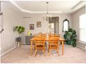 Warm and inviting dining room features natural wood furniture, complemented by a tray ceiling and stylish decor at 5769 Marsh Glen Ct, Carmel, IN 46033