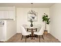 Cozy dining area with a modern chandelier, round glass table and seating for four at 6014 Wildcat Dr, Indianapolis, IN 46203