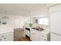 Open concept kitchen with stainless steel sink, white appliances and a view to the living area at 6014 Wildcat Dr, Indianapolis, IN 46203