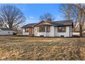 Inviting single-Gathering home displaying updated exterior features, a landscaped yard, and a welcoming curb appeal at 6470 Jackson St, Indianapolis, IN 46241