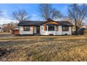 Delightful single-story home presenting a classic facade, a cozy entrance, and a tidy lawn at 6470 Jackson St, Indianapolis, IN 46241