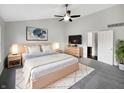 Comfortable main bedroom featuring a ceiling fan, a picture window and a cozy rug under the bed at 7213 Shag Oak Dr, Noblesville, IN 46062