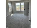 Bedroom with plush carpet, natural light from the three pane windows, and a neutral color palette at 764 Oakleaf Dr, Greenfield, IN 46140