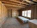 Unfinished room with wooden framing, insulation, and windows showcasing the construction phase of the house at 764 Oakleaf Dr, Greenfield, IN 46140
