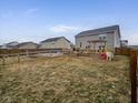 Spacious backyard featuring a wooden deck with pergola, play structure, and ample room for outdoor activities at 8430 Templederry Dr, Brownsburg, IN 46112