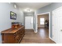 Inviting foyer showcasing wood flooring, a decorative dresser, and a view into a bright office space at 8430 Templederry Dr, Brownsburg, IN 46112