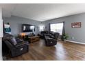 Comfortable living room with wood floors, leather reclining furniture, and a cozy atmosphere at 8430 Templederry Dr, Brownsburg, IN 46112