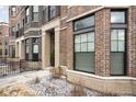 Brick townhome exterior with bay window, showcasing the manicured front yard at 946 Berkhamsted Ln, Carmel, IN 46032