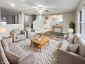 Bright and spacious living room with neutral walls and a large rug, perfect for entertaining at 976 Peppermint Ct, Greenfield, IN 46140