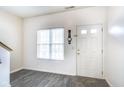 Bright entryway featuring light gray flooring, white walls, a window and traditional white front door at 9769 Green Knoll Dr, Noblesville, IN 46060